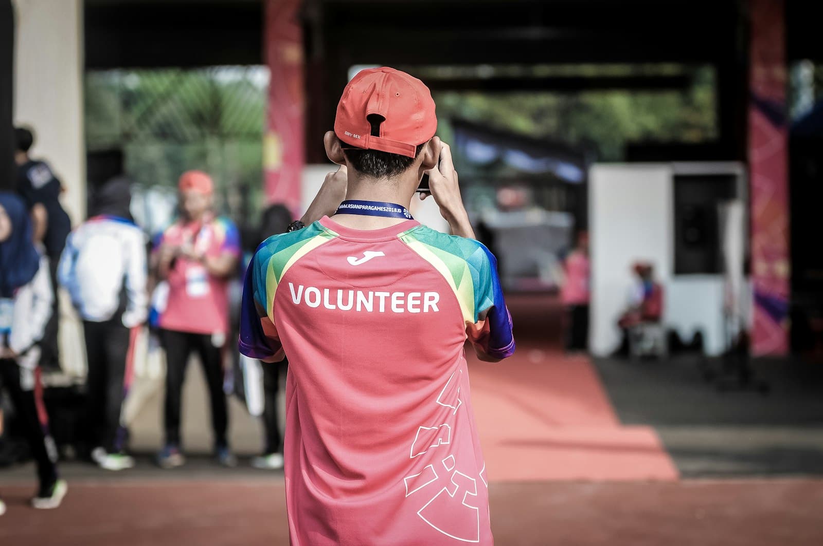 A volunteer in a bright t-shirt at a community event