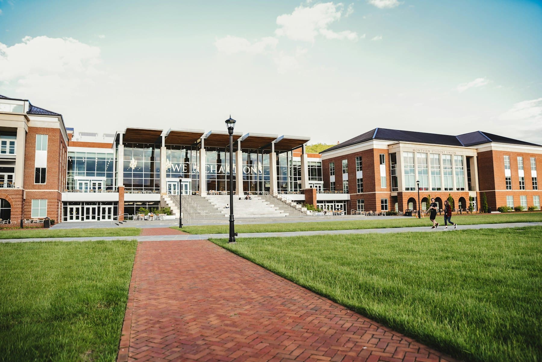 A university campus with a brick pathway leading to modern buildings