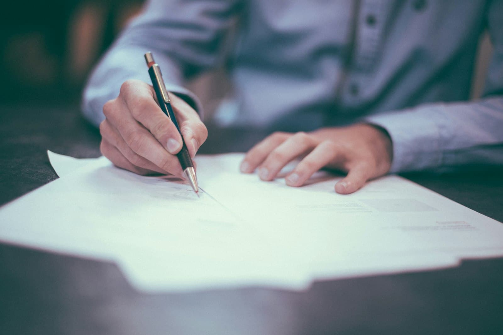 A person signing official documents